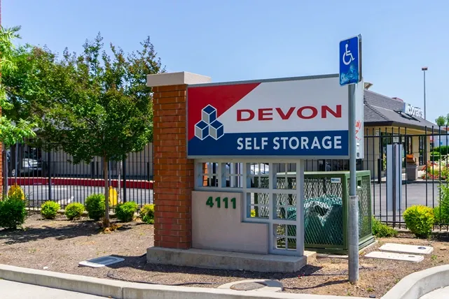 Devon Self Storage facility sign with address and roadside visibility